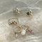 Twist earring with round stone and gold details