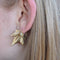 Twist earring with round stone and gold details