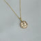 Small gold pendant with sapphire