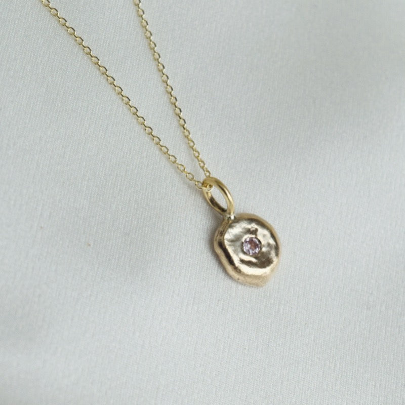 Small gold pendant with sapphire